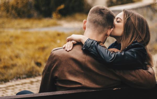 Woman kissing boyfriend on cheek